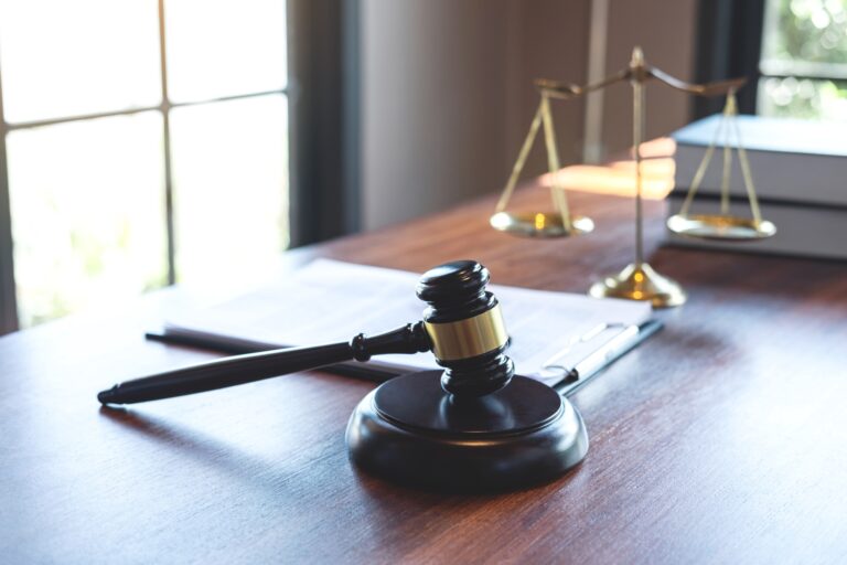 Judge gavel with Justice at law firm in background with legal case document contract