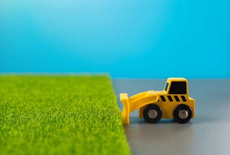 Bulldozer clears fertile land for construction.