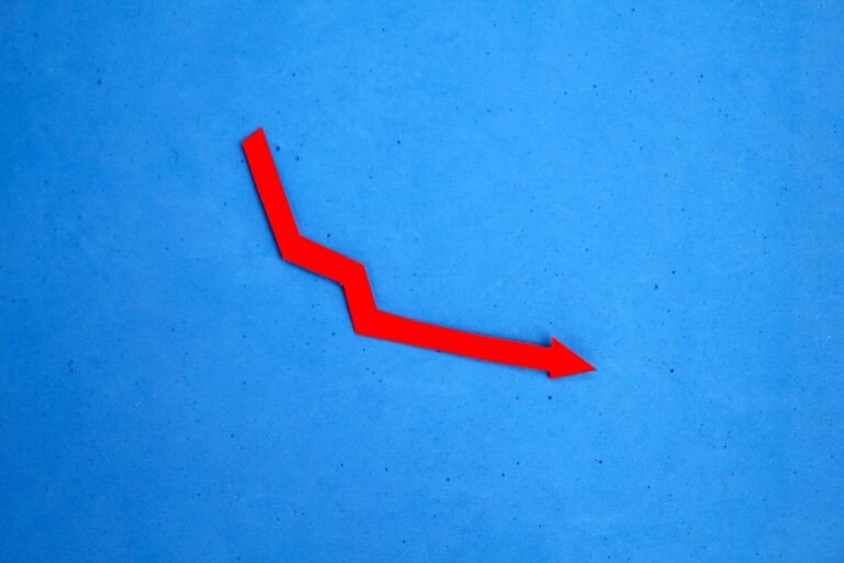 red arrow pointing down. the concept of devaluation.